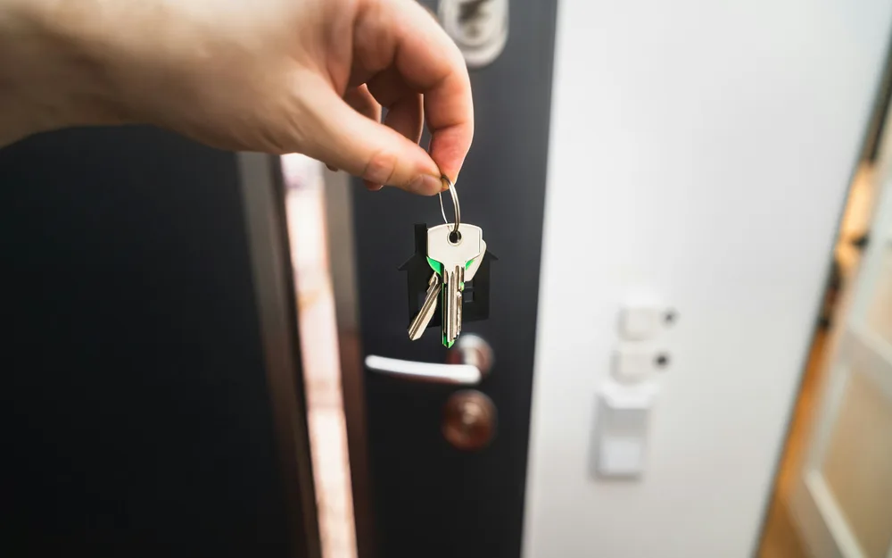 House key in the front door of a new home